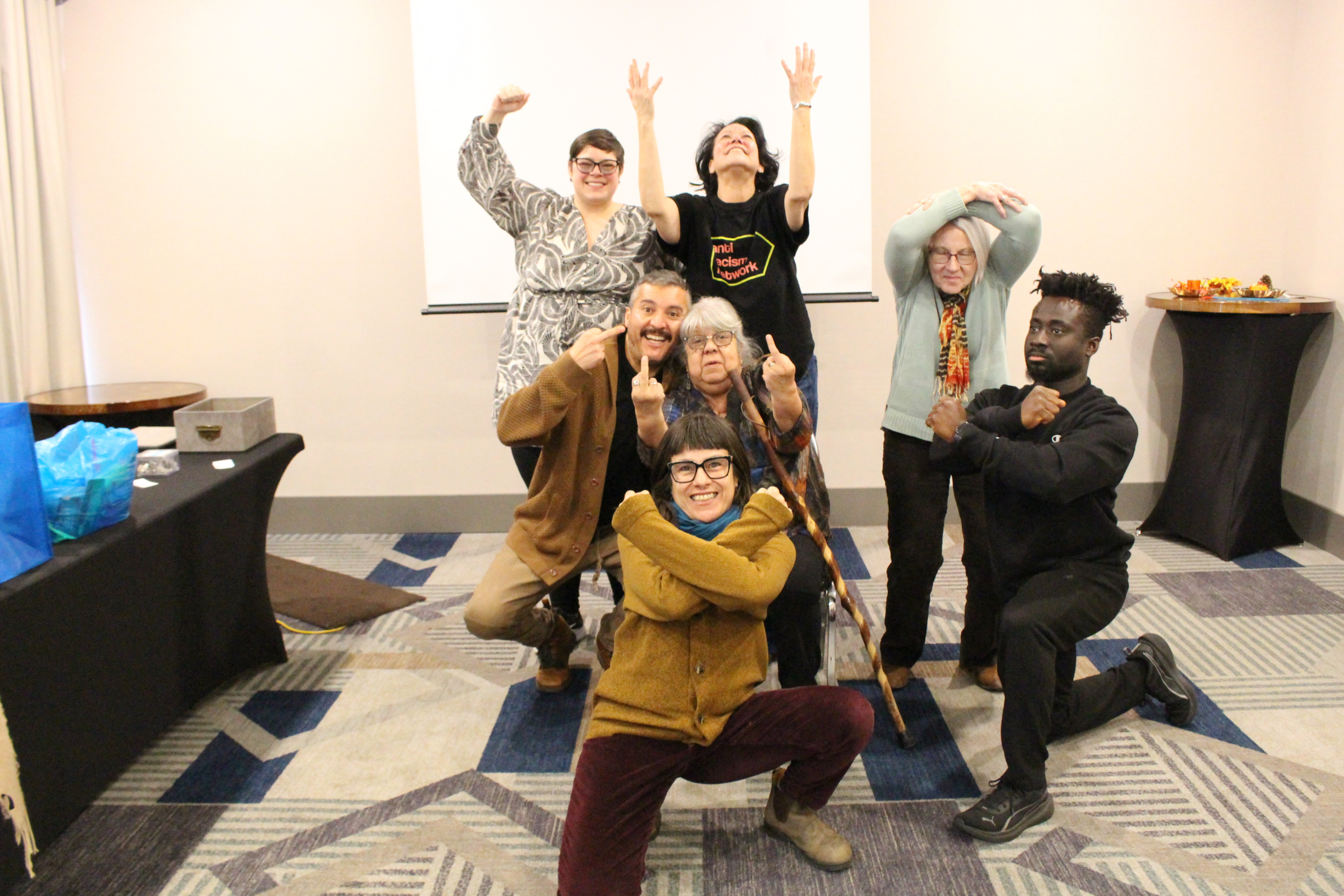 A photo of a group of people in a tableau, each assuming a different pose