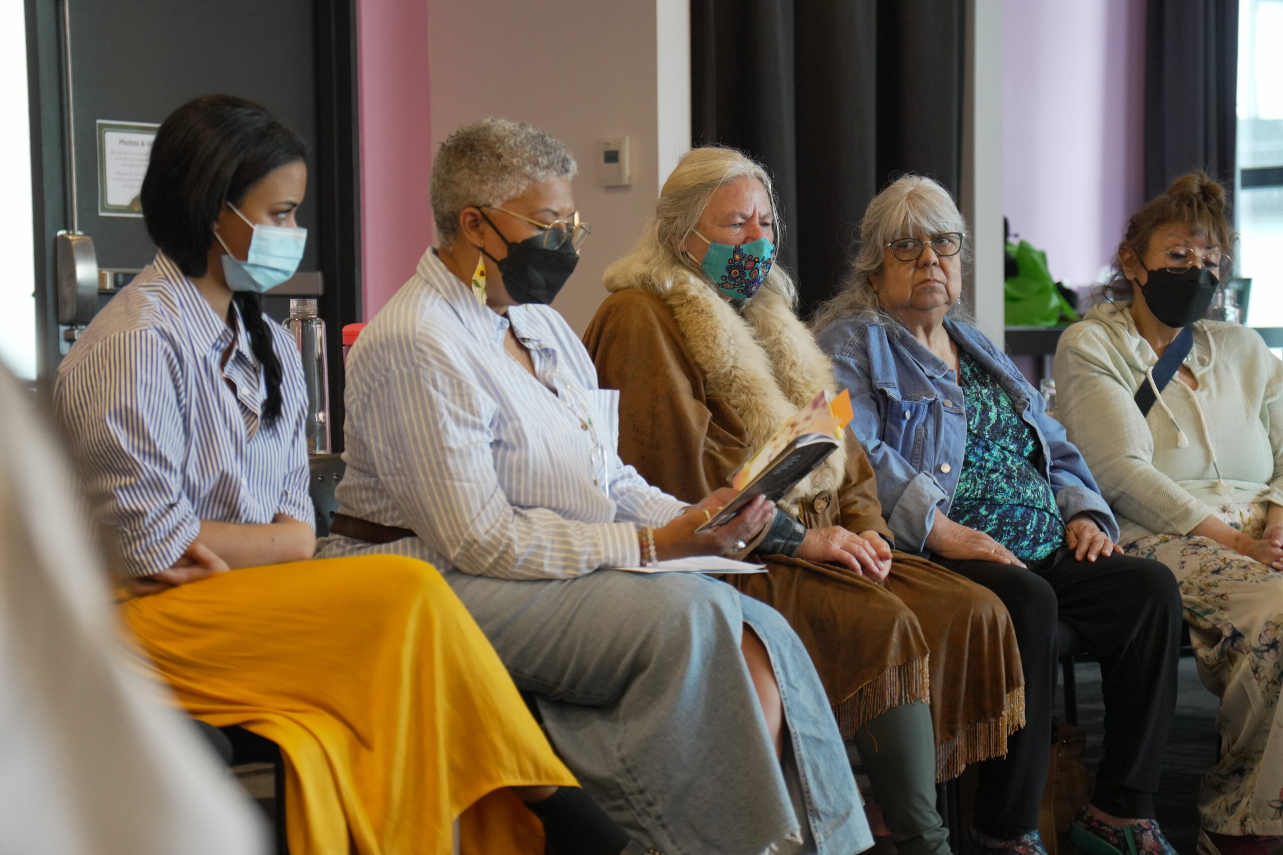 A photo of participants seated in a semi-circle