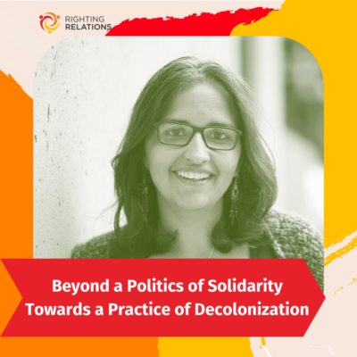 A green-toned, grayscale image of a woman with glasses and shoulder-length hair smiling towards the camera. Text at the bottom reads "Beyond a Politics of Solidarity: Towards a Practice of Decolonization